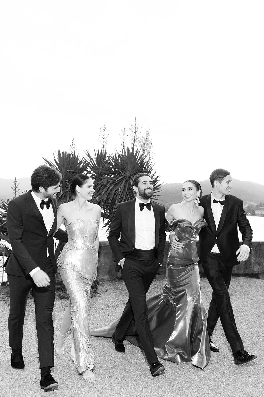 Black-and-white photo of elegant guests walking at Villa Pizzo