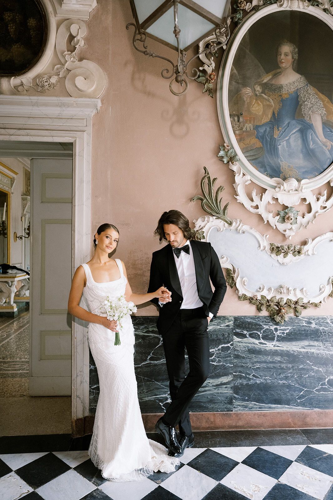 Couple in a frescoed hall with a chequered floor at Villa Pizzo