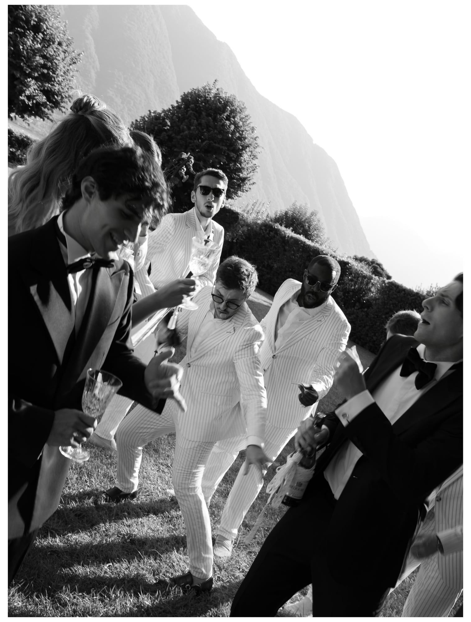 Black and white photo of guests dancing with musicians at a Lake Como wedding