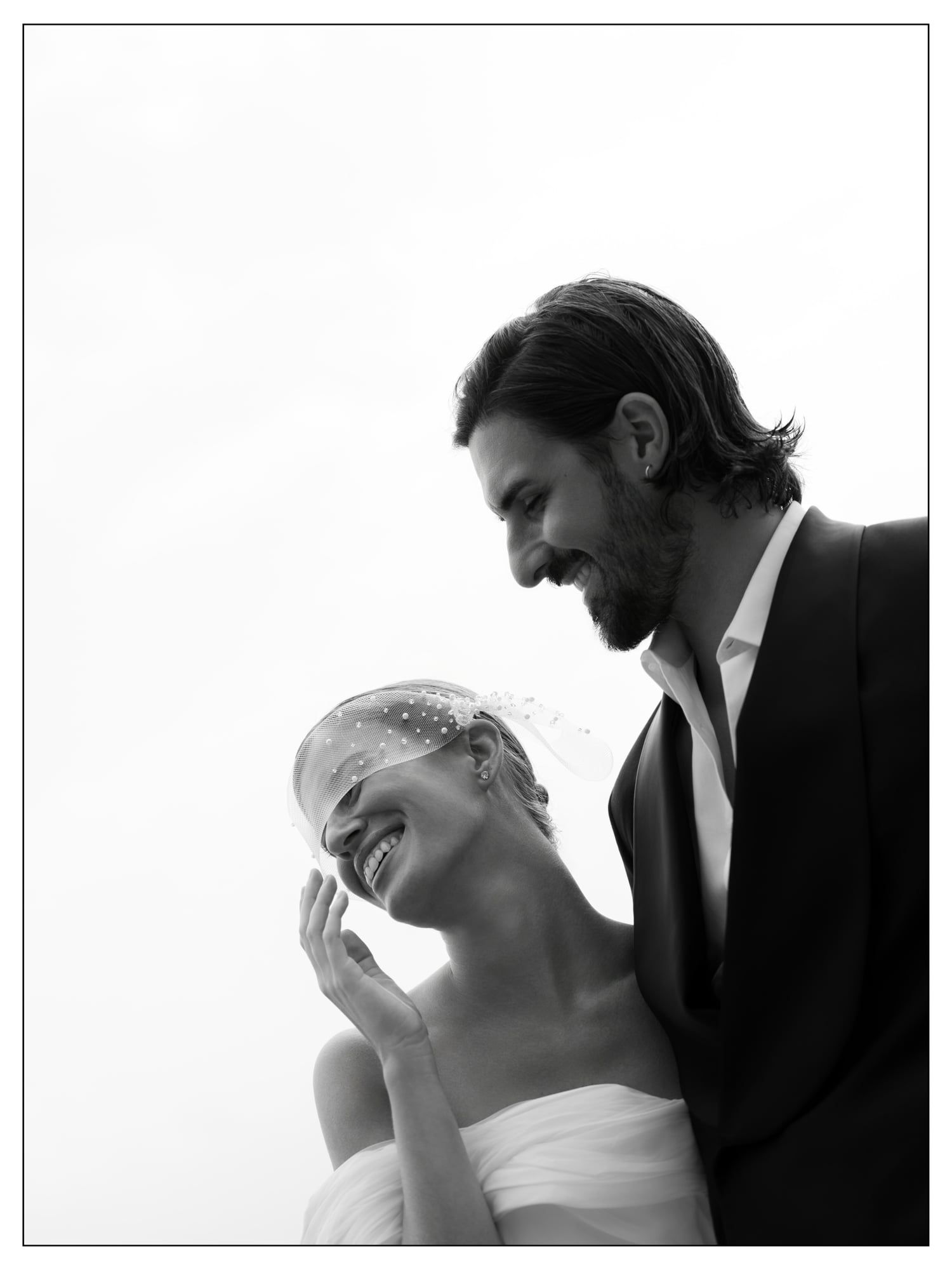 Black and white portrait of a laughing bride and groom by Lake Como