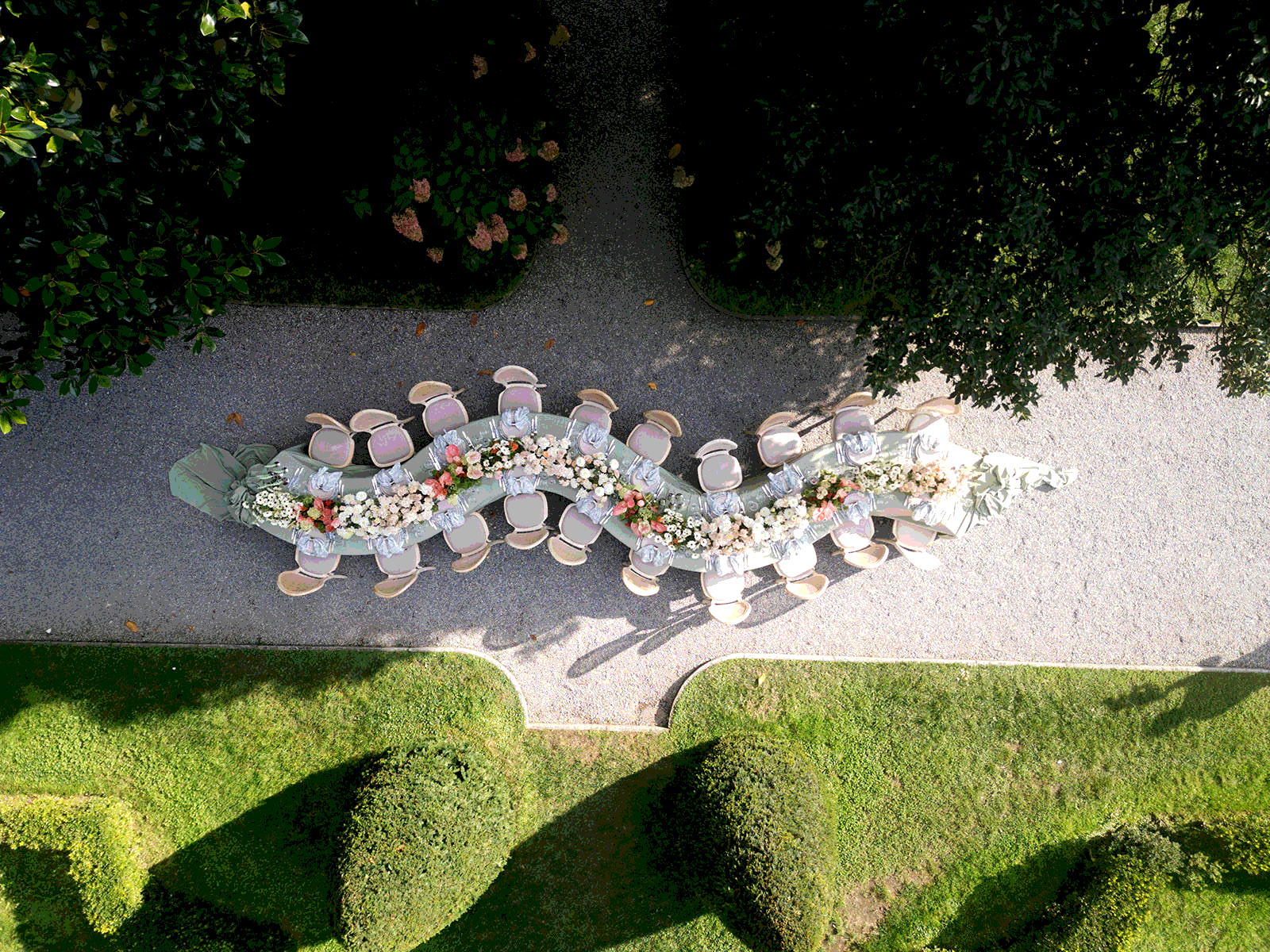 Aerial view of a winding wedding table in a garden on Lake Como