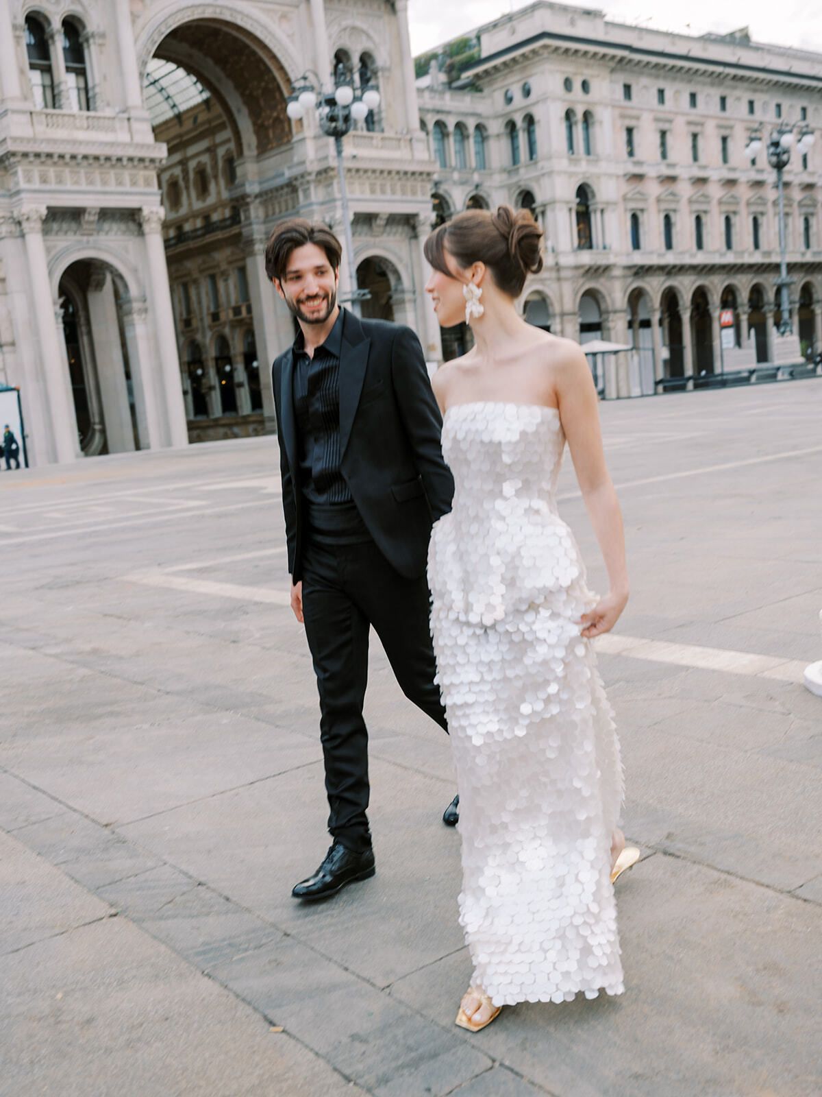 Couple in front of the Galleria Vittorio Emanuele II arch, Milan