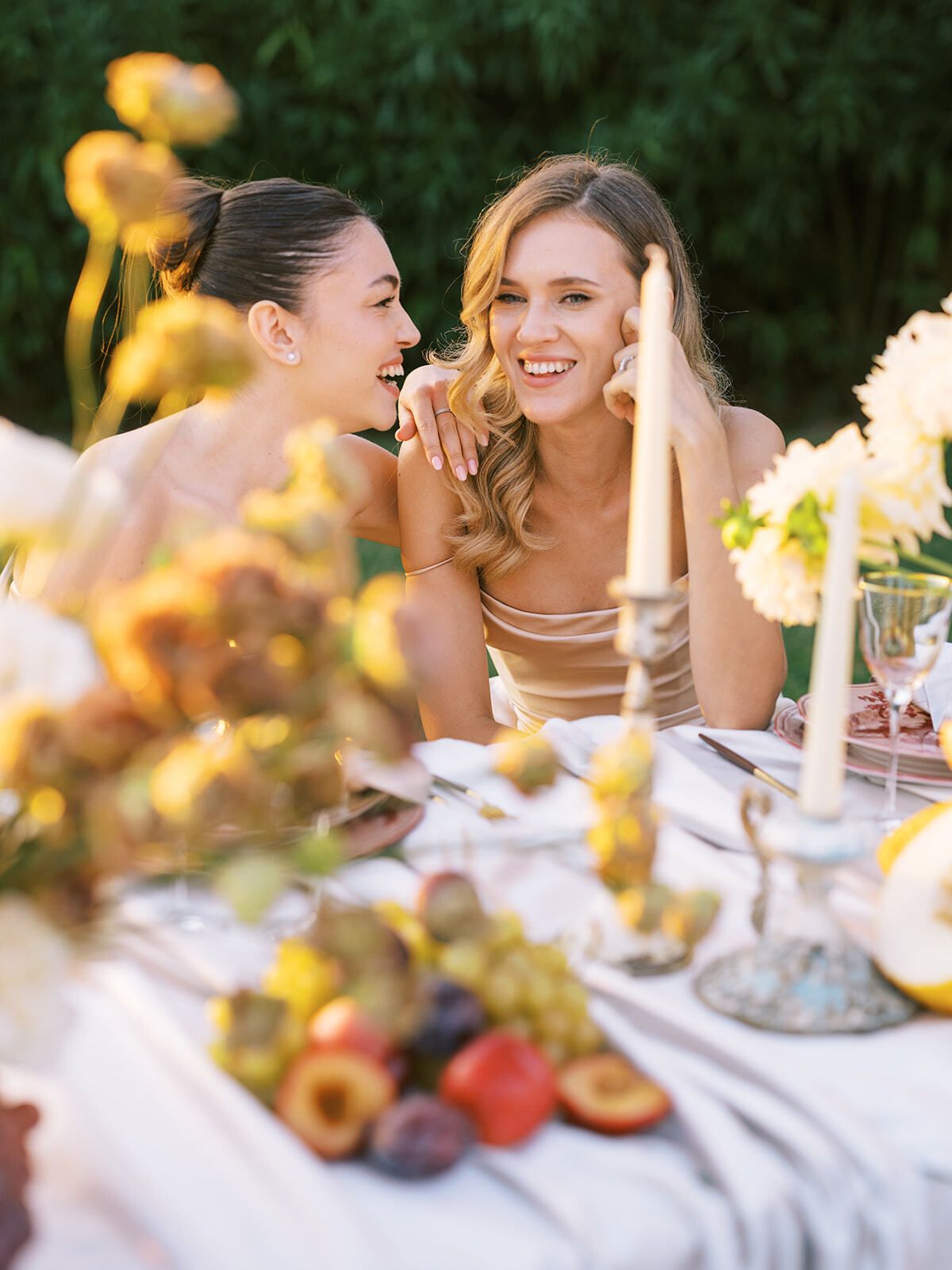 Damas de honor riendo en la mesa del banquete