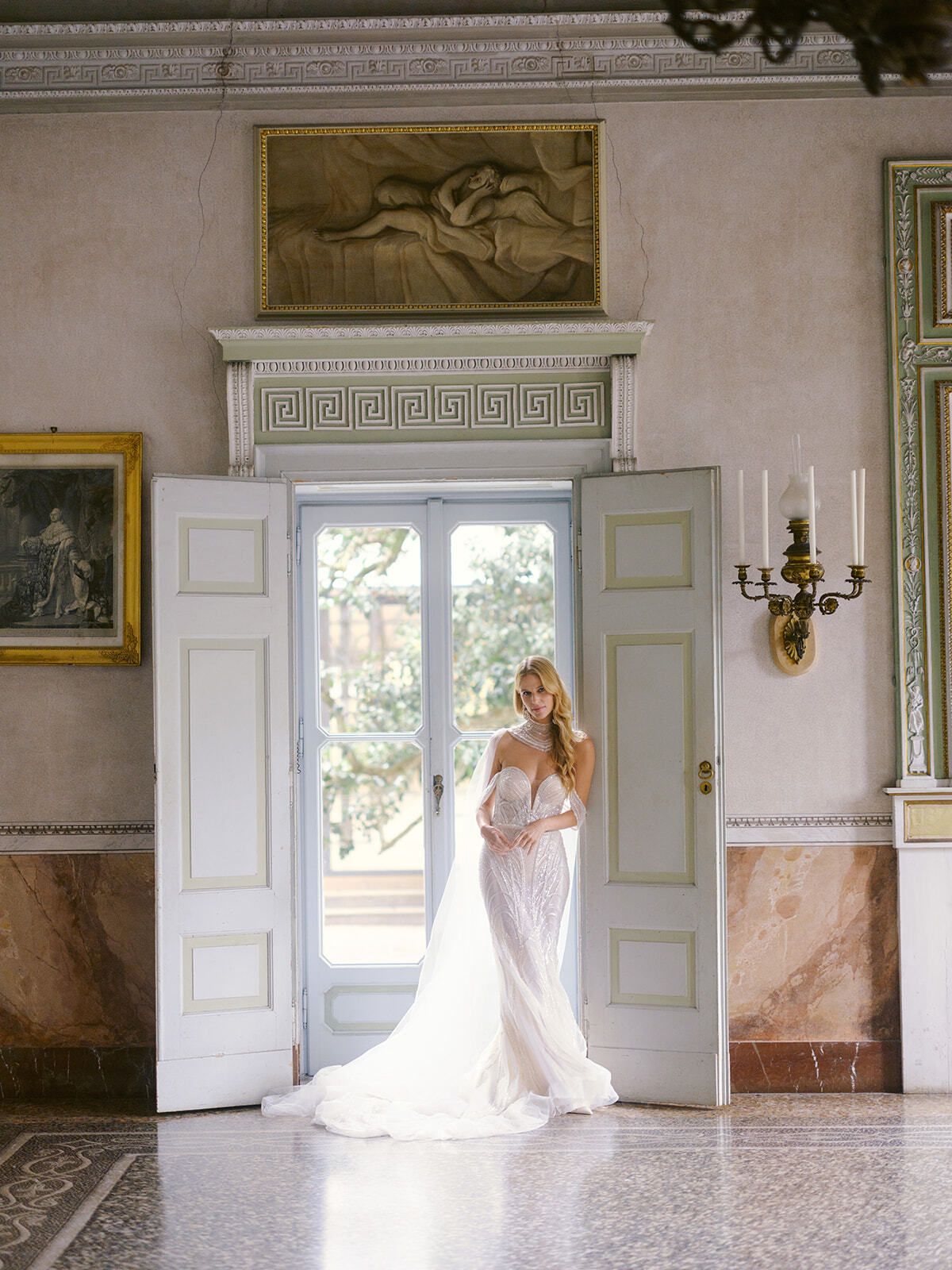 Mariée sur le seuil d’un salon à fresques de la Villa Pizzo