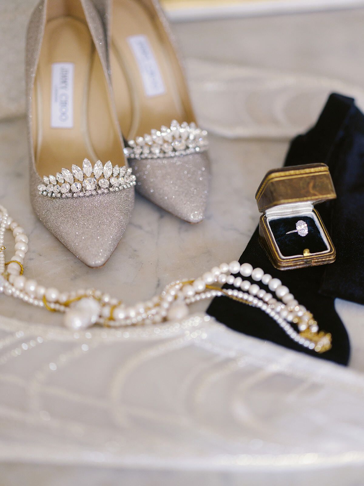 Crystal-embellished heels, a ring box and pearl jewellery