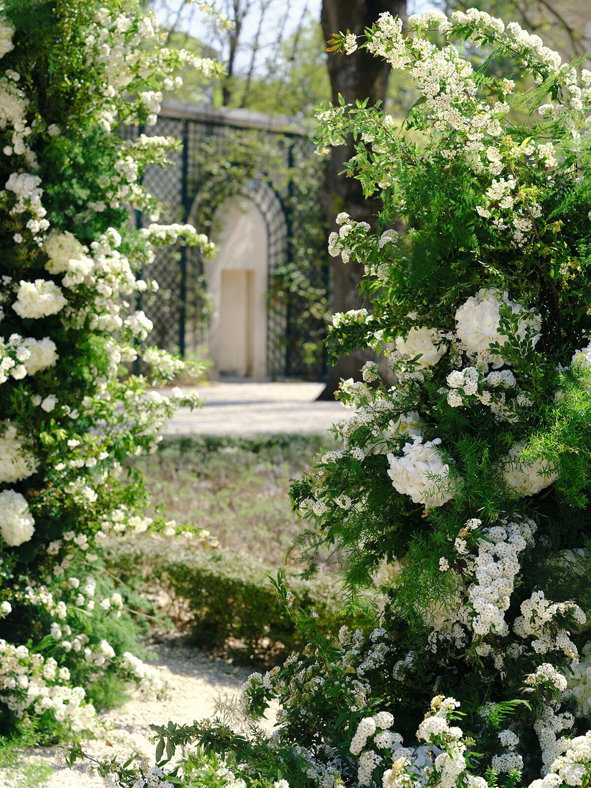 Arco de flores blancas en los jardines del Château Martinay