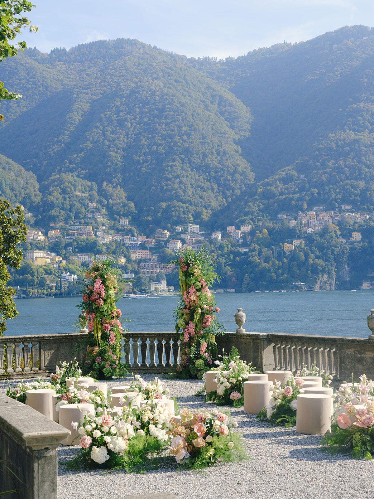 Terrasse de cérémonie avec fleurs et colonnes florales au bord du lac
