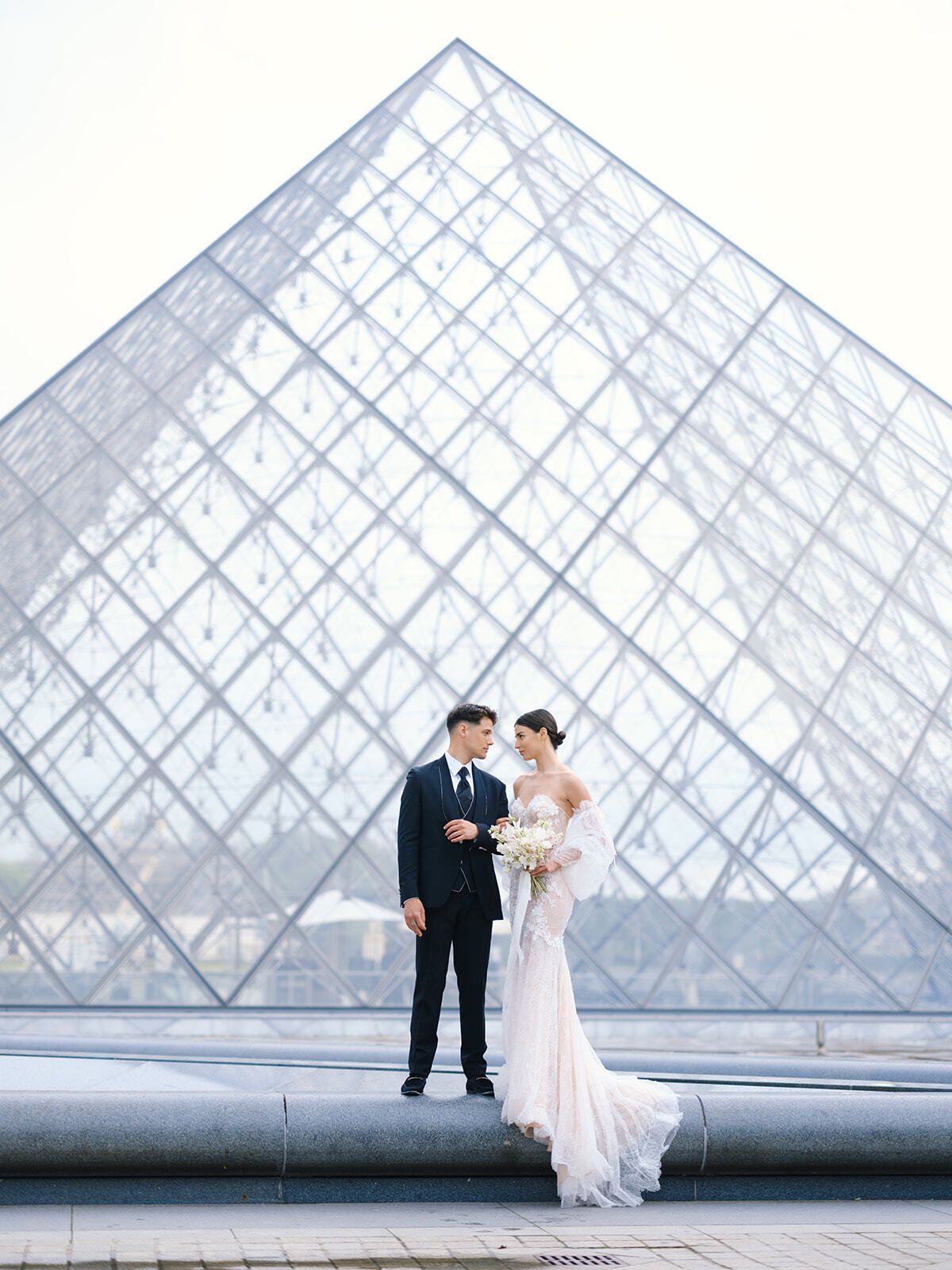 Brautpaar vor der gläsernen Louvre-Pyramide