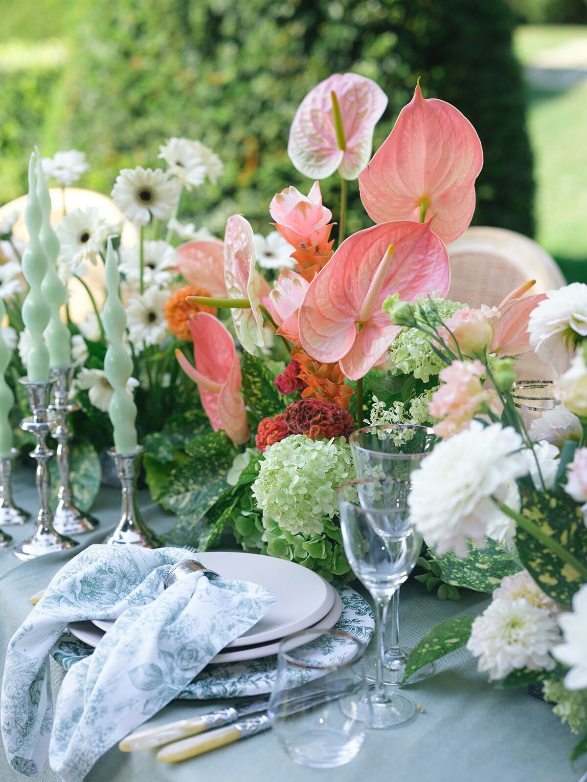 Centrepiece of pink anthuriums and white flowers