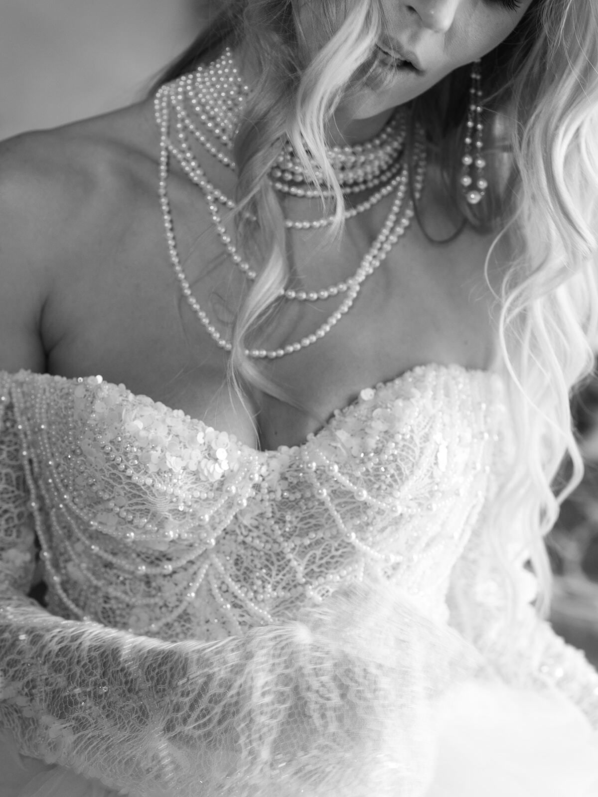 Black-and-white close-up of a beaded bodice and pearl necklaces