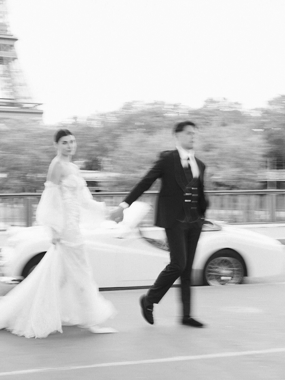 Schwarz-Weiß-Foto: Paar läuft an einem Oldtimer vorbei, Paris