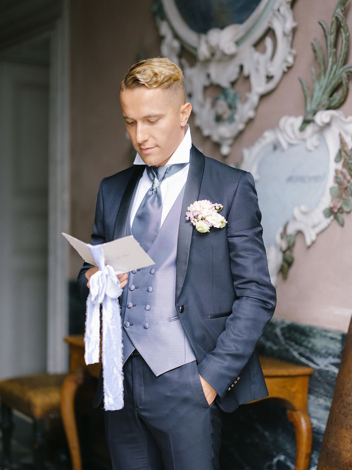 Novio leyendo una carta de la novia en un salón de la villa